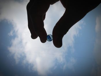 Low section of silhouette person against sky