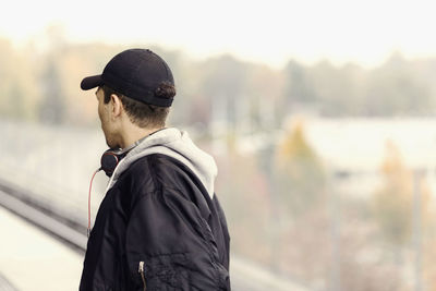 Rear view of man looking at camera