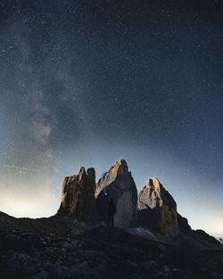 Low angle view of rocks against sky at night