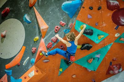 Young spiderman on the multicolored wall