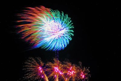 Low angle view of firework display at night