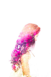 Double exposure of woman and pink flowers against white background