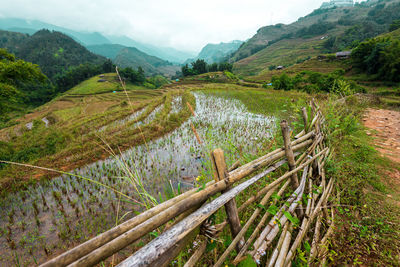 Scenic view of land and mountains against sky