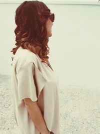 Rear view of woman standing at beach