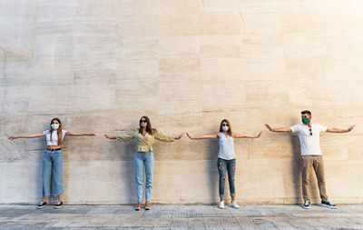 Group of people standing against wall