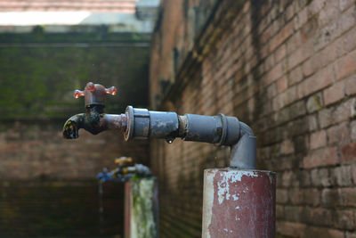 Close-up of faucet against wall