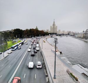 High angle view of traffic on road by buildings against sky