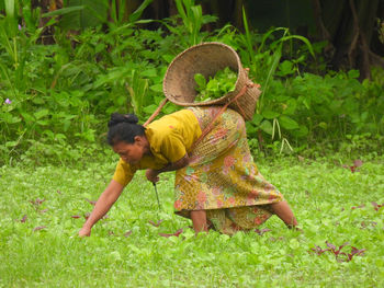 Rear view of boy standing on field