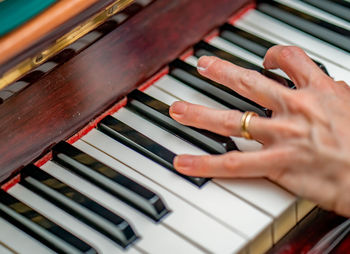 Midsection of woman playing piano