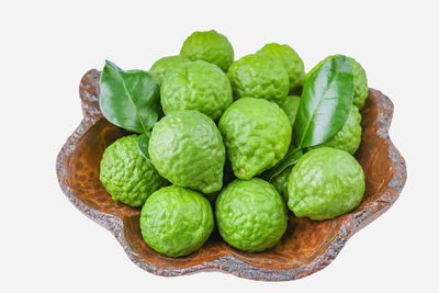 High angle view of green fruits on white background