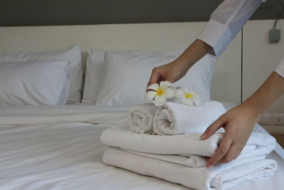 Midsection of woman relaxing on bed