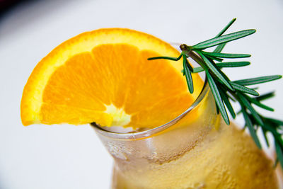 Close-up of orange drink against white background