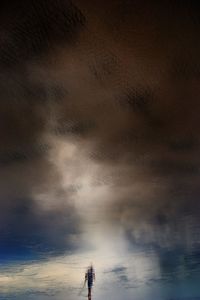 Silhouette of man against cloudy sky