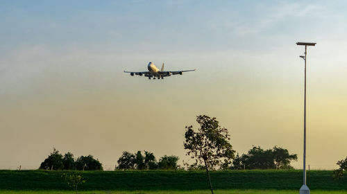 Low angle view of airplane flying against sky