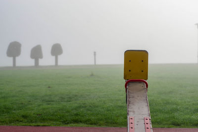 Close-up of wooden post against clear sky