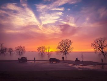 Silhouette trees against sky during winter