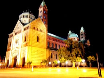 Illuminated building against sky at night