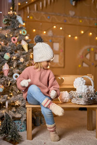 Rear view of woman sitting on table