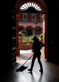Rear view of man standing at entrance of building