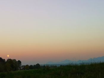 Scenic view of field against sky during sunset