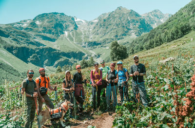 Group of people against mountain range