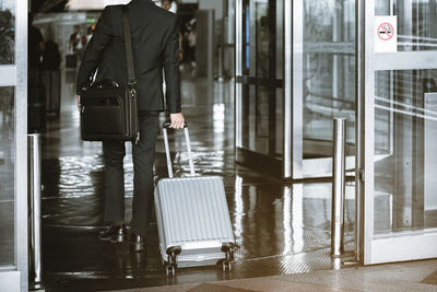 Man with umbrella standing at airport