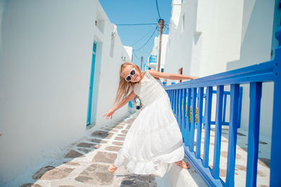 Woman standing on white railing