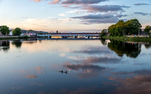 Scenic view of lake against sky at sunset