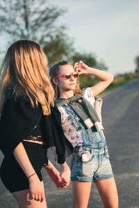 Friends standing on road in city