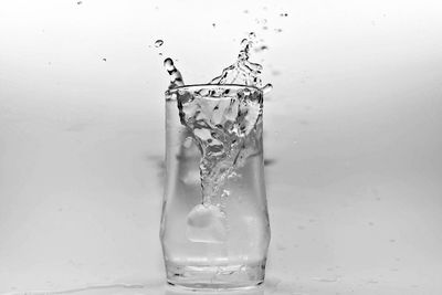 Close-up of water splashing on glass