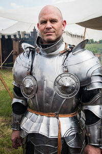 Portrait of man in knight costume standing on field during festival
