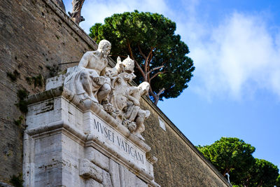 Low angle view of statue against sky in front of the vatican mseum