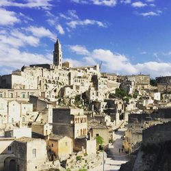 View of cityscape against cloudy sky