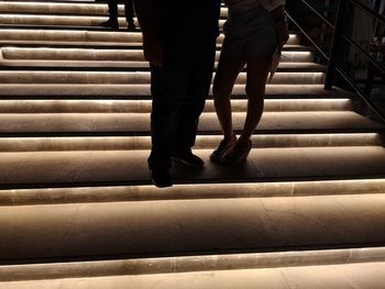 Low section of people walking on staircase