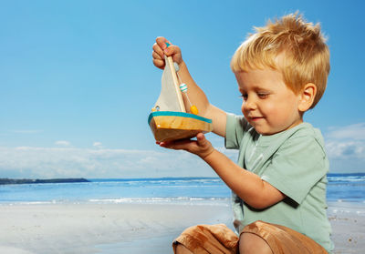 Portrait of boy eating ice cream at beach