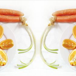 Close-up of orange slices on table against white background