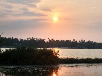 Scenic view of calm lake at sunset