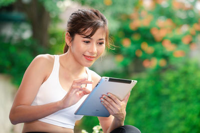 Young woman using mobile phone outdoors