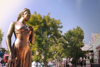 Low angle view of statue against trees