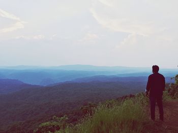 Rear view of woman looking at mountain landscape