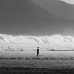 Man standing on beach against sky