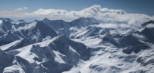 Scenic view of snowcapped mountains against sky