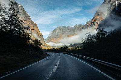 Road amidst mountains against sky