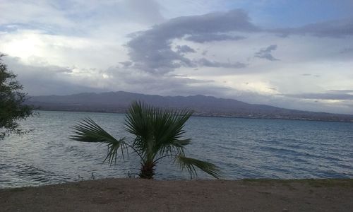 Scenic view of sea against cloudy sky