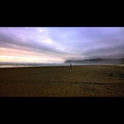 Scenic view of landscape against cloudy sky