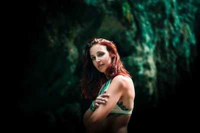 Portrait of a beautiful young woman standing outdoors