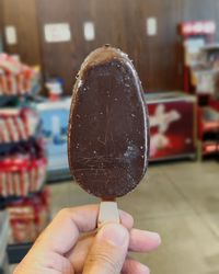 Close-up of hand holding ice cream cone