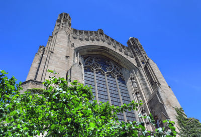 Low angle view of building against clear blue sky