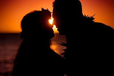 Silhouette people against sky during sunset