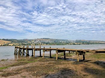 Pier over lake against sky